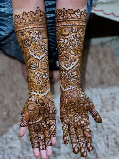 A full view of a non-bridal design, showing the intricate patterns covering both hands and extending up the arms.