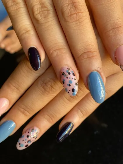 A full view of the mismatched nail art, showing how the different designs and colors work together.