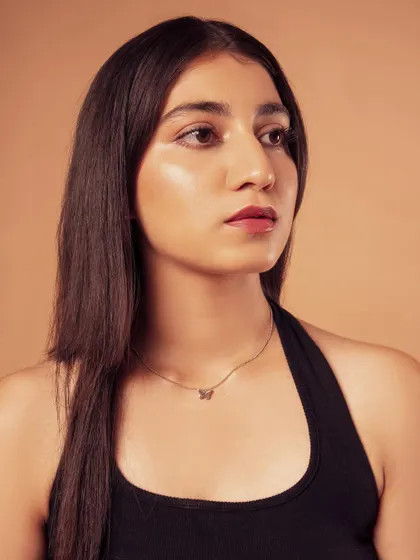 A profile shot that highlights the model's features and the soft lighting on her skin.
