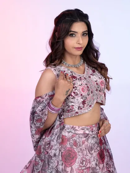 A closer look at this beautiful floral print lehenga. The cold-shoulder blouse design and delicate silver embroidery add a contemporary feel to the romantic rose pattern.
