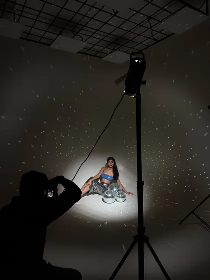 Another angle of me at work, showing how I position myself to capture the best light and interaction with the props.