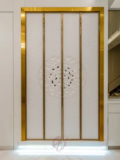 The mandir doors closed, showcasing the intricate, custom-designed 3D pattern on the exterior. The design is both a beautiful decorative element and a respectful enclosure for the sacred space within.