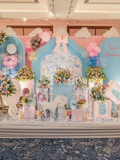 Another stunning stage setup for a Dior-themed shower, with a full backdrop, themed props, and beautiful floral arrangements.