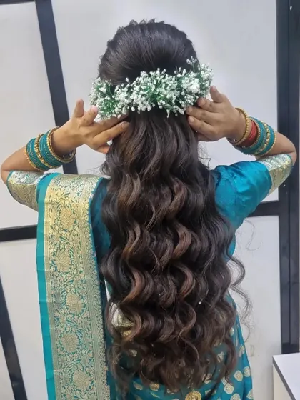 A beautiful and soft engagement hairstyle. I created a half-up, half-down look with a side braid and gentle waves, decorated with baby's breath flowers.