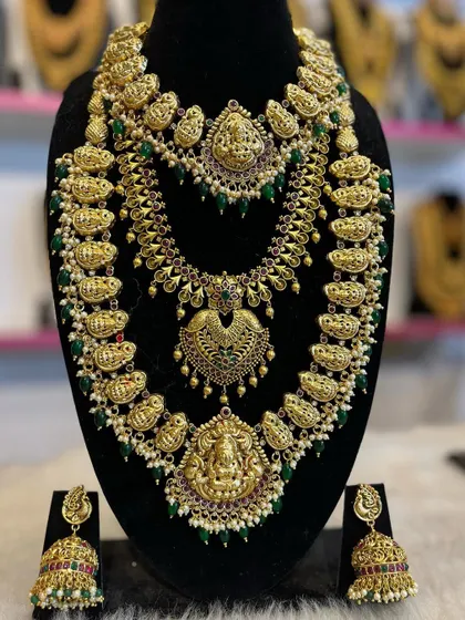 A mango-motif haram set with green bead accents. This is a vibrant and beautiful choice that pairs well with many silk sarees.