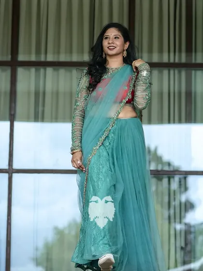 A full-length view of Kritika's unique outfit, showcasing the off-beat fabric and color combination.