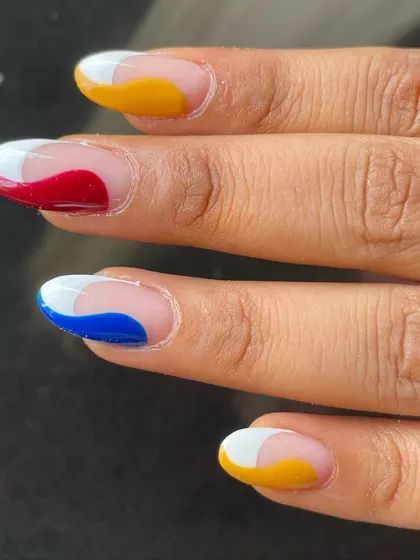 A close-up of the primary color abstract French tips. The negative space keeps the design looking modern and fresh.
