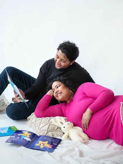 Reading stories to the baby bump is a beautiful way to bond. This setup is perfect for capturing the quiet, tender moments of preparation for parenthood.