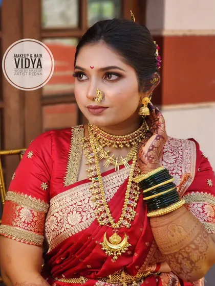 Priya looking absolutely stunning. This shot highlights her flawless makeup, the crescent moon necklace, and the traditional Maharashtrian nath.