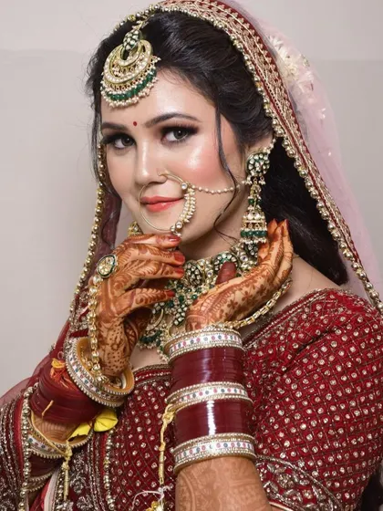 This close-up highlights the fine details of a bridal nath and the matching green-beaded Kundan necklace from our rental collection.