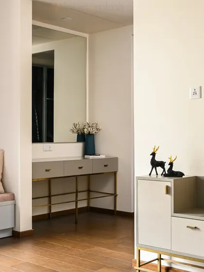 A stylish dressing area with a minimalist console table, a large mirror, and elegant decor. This space is perfect for getting ready in the morning.