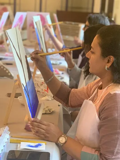 A guest engrossed in her painting at the Kochi workshop. The picturesque backdrop of Fort Kochi added to the creative ambiance.