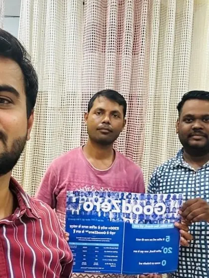 Our team with a customer holding our "GoodZero" brochure.