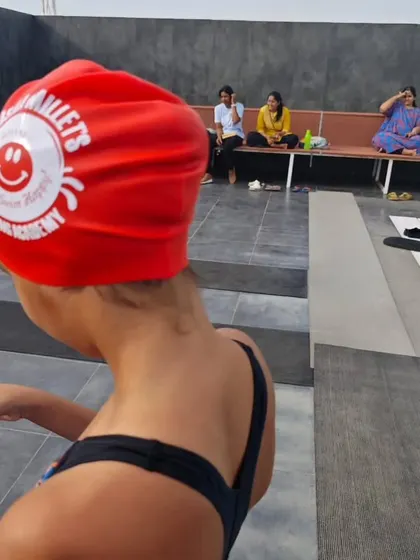 A close-up of our NMSA swim cap. Our motto is "Don't Worry, Swim Happy," and we live by it every day.