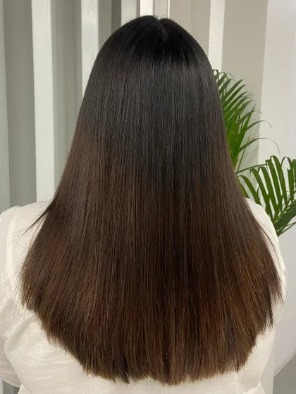 A back view showcasing the sleek, uniform finish of a hair smoothening treatment. Notice the healthy shine and the perfectly straight ends.