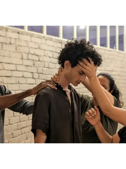 A powerful moment of support and healing. Students use gentle touch and presence to help a fellow participant release tension and find grounding.