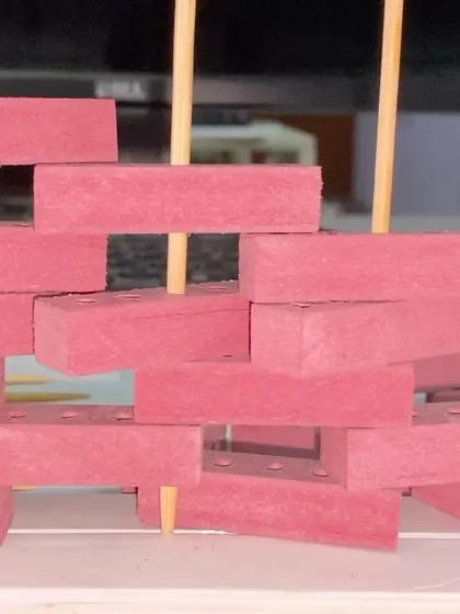 A close-up of the physical study model for the 'Brick Weave House'.