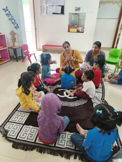 A beautiful moment of community and learning. A guide sits with a group of children for a circle time lesson, a time for stories, songs, and shared experiences that build our classroom family.