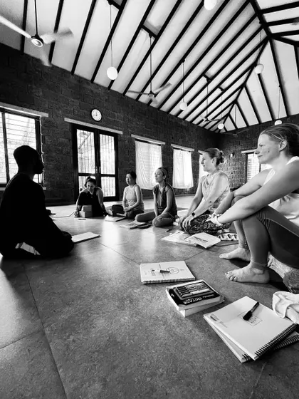 A teacher leads a discussion with a small group of students. These intimate conversations are where some of the most profound learning happens during our teacher training.