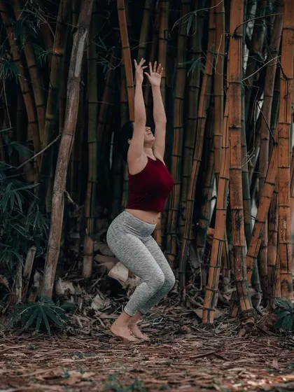 Utkatasana, or Chair Pose, in a bamboo forest. While it may seem simple, this pose builds serious heat and strength in the legs and core, which is foundational for more advanced asanas.