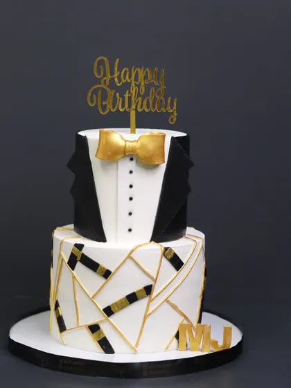 Refined, bold, and irresistible. My Gentlemen Cake is crafted for those who appreciate the finer things, featuring a sharp tuxedo design on the top tier and a modern geometric pattern below.