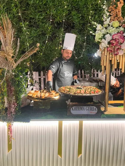A chef in action at the Kheema Gurda station, surrounded by elegant decor.
