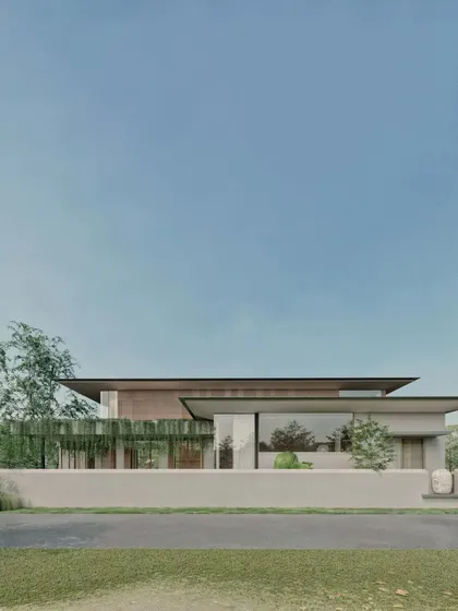 The street view of the Sanctuary Residence shows a composition of clean lines and natural materials, with a low wall providing privacy while hinting at the serene spaces within.