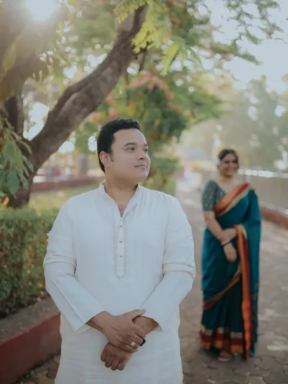 A creative portrait with the groom in the foreground and the bride softly focused in the back. It tells a story of anticipation and love.