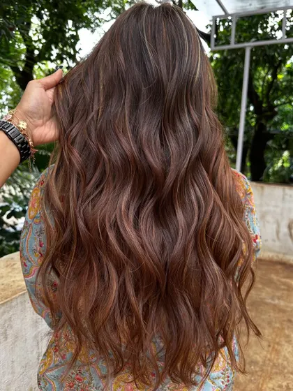 The back view of her rich copper and caramel holiday hair.