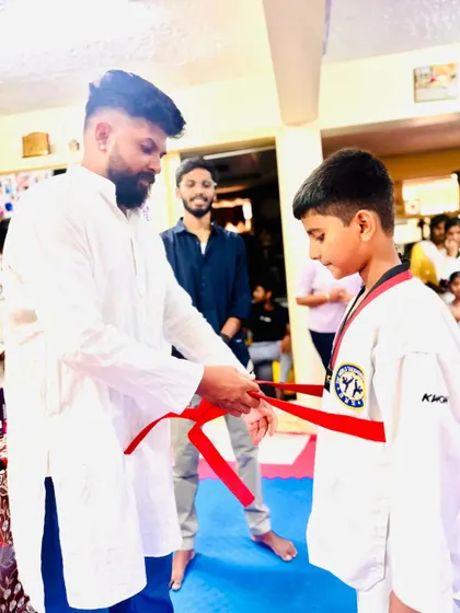 This student has worked hard to earn his red belt.
