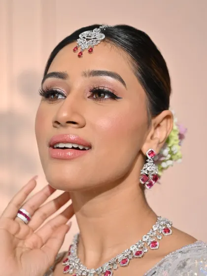 A close-up focusing on the flawless skin and soft pink lips. This look is a perfect example of modern minimalism, where the makeup enhances rather than masks.