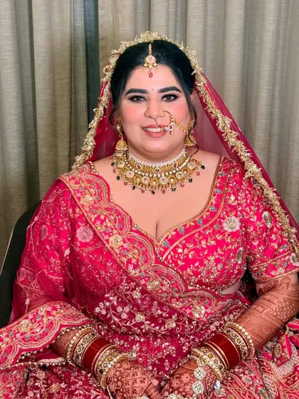 The beautiful bride Shrishti, all smiles for her pheras. Her makeup is classic and timeless, with a focus on flawless skin and expressive eyes.