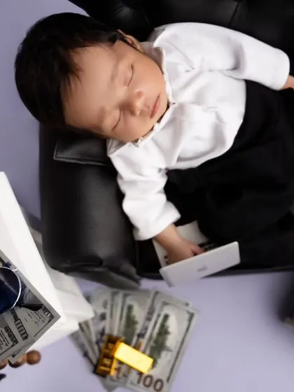 Even a boss baby needs his rest. This overhead shot captures the full setup with all the fun props like a mini phone and stacks of cash.