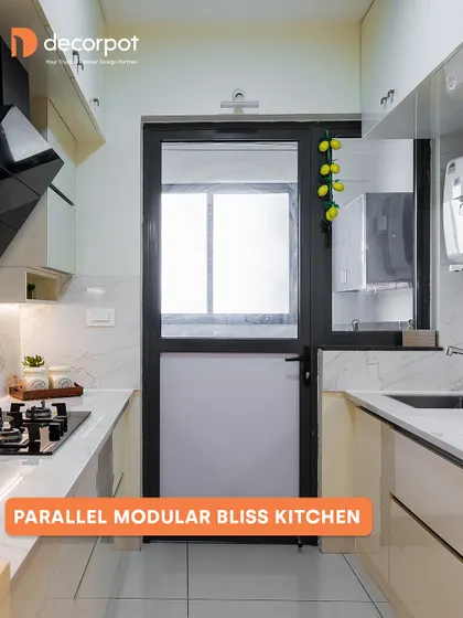 Our 'Parallel Modular Bliss' kitchen is perfect for narrow spaces. The clean, off-white cabinets and marble-patterned backsplash make the area feel bright and open, while the layout ensures a practical and efficient cooking workflow.