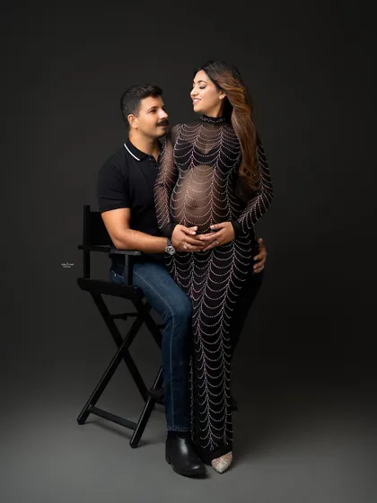 A stylish and modern couple's portrait. The mamma looks stunning in the embellished gown, and the pose is full of connection.