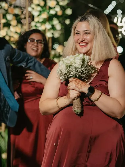 The moment of the surprise proposal, with the bridesmaid catching the bouquet.
