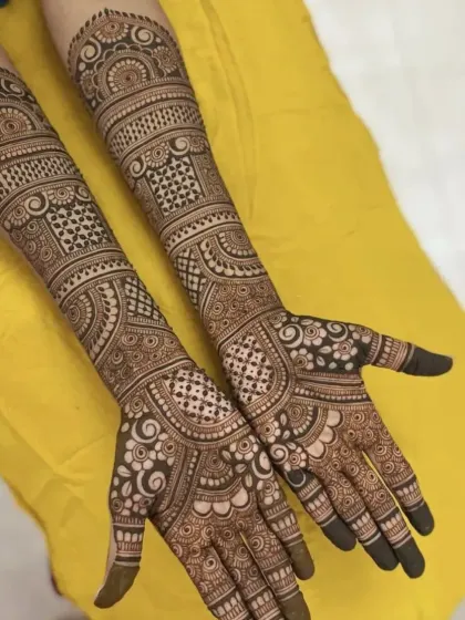 This design combines geometric grids with flowing, organic patterns. It's a versatile look that suits many different bridal styles.
