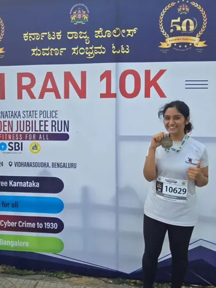 Posing with her medal, this team member shows the pride of finishing a challenging race.