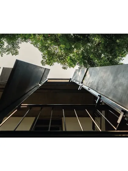 A worm's-eye view of the facade's concrete fins. This perspective emphasizes their slender profile and the rhythmic pattern they create, showcasing the technical precision of the ultra-high-performance concrete fabrication.
