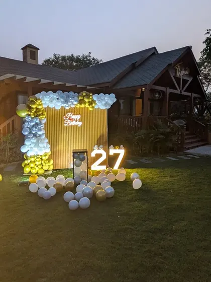 A wide perspective of the party setup in a beautiful farmhouse garden, perfect for larger celebrations.