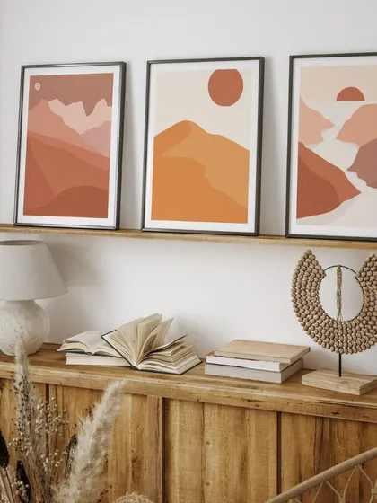 A beautiful triptych of boho-inspired landscape prints. The warm, earthy tones depicting the sun, mountains, and river create a serene and cohesive look, perfect for adding a touch of wanderlust to your decor.