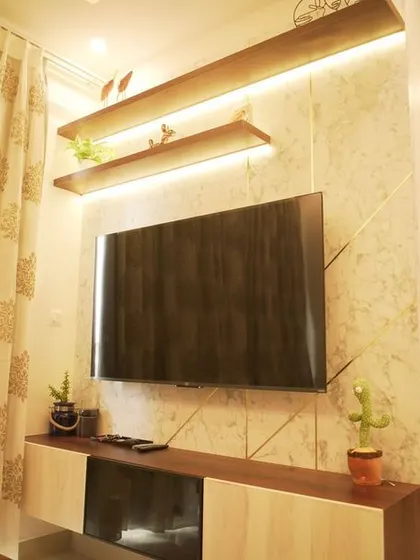A close-up of the TV unit with its textured back panel and backlit floating shelves, perfect for displaying small decorative items.