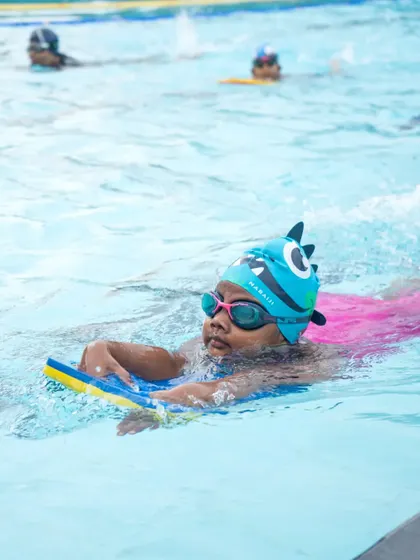 This young swimmer is developing confidence and coordination. We use fun equipment to make learning essential athletic skills exciting.
