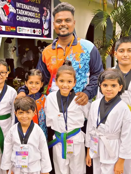 A group photo with our Taekwondo champions, showcasing the different belt levels and age groups that compete and succeed together.
