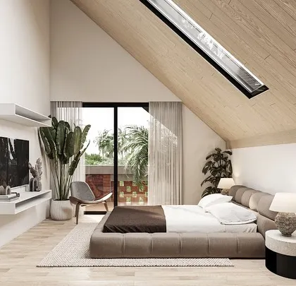 The master suite in our Kolgaon Masterplan is housed on the top level under a sloping wooden roof. A large skylight and a private balcony with perforated brick walls give the bedroom an expansive, light-filled character.