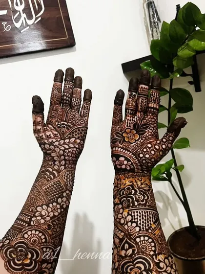 A classic full-arm bridal design with a mix of floral and Pakistani-style elements.