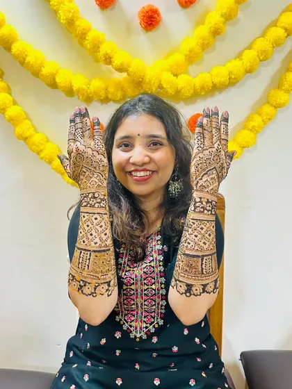 The bride's mother, also with beautiful, full-coverage mehendi. We make sure the whole family is included in the celebration.