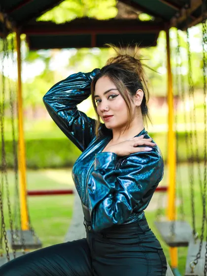 A playful pose from the same park shoot, capturing a sense of fun and energy.