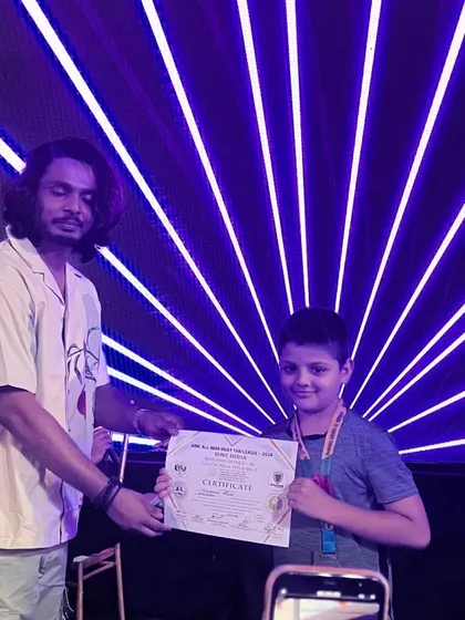 Another shot of our young fighter getting his award at the national championship. We are proud of his hard work.