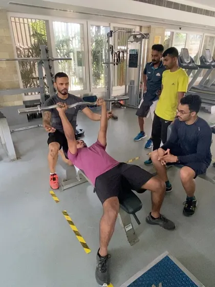 Correcting form on the bench press during a CSCS practical session. My mentorship focuses on providing immediate, specific feedback to help coaches master the fundamental lifts and effectively teach them to their own athletes.